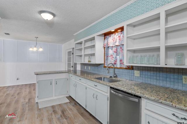 kitchen featuring sink, white cabinetry, stainless steel dishwasher, and light stone countertops