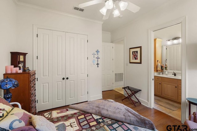 4007 Spartanburg Ln, Tyler, TX 75701 - bedroom featuring a closet, wood finished floors, a sink, crown molding, and ceiling fan