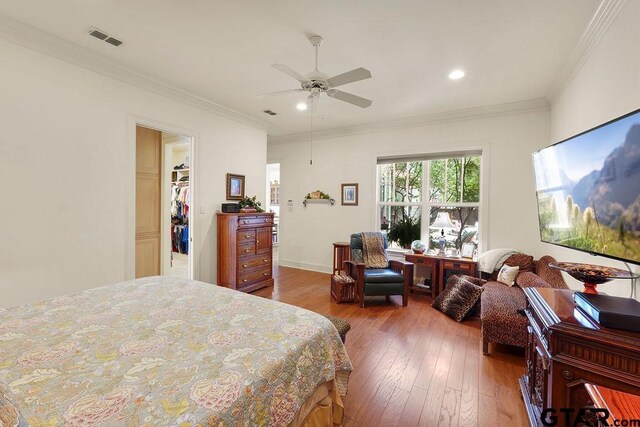 4007 Spartanburg Ln, Tyler, TX 75701 - bedroom featuring hardwood / wood-style floors, recessed lighting, crown molding, ceiling fan, and a walk in closet