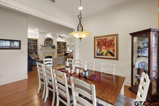 4007 Spartanburg Ln, Tyler, TX 75701 - dining space featuring a ceiling fan, ornamental molding, wood finished floors, baseboards, and a premium fireplace