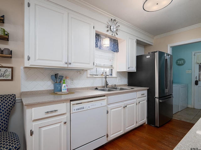 kitchen with sink, stainless steel fridge, backsplash, white dishwasher, and white cabinets