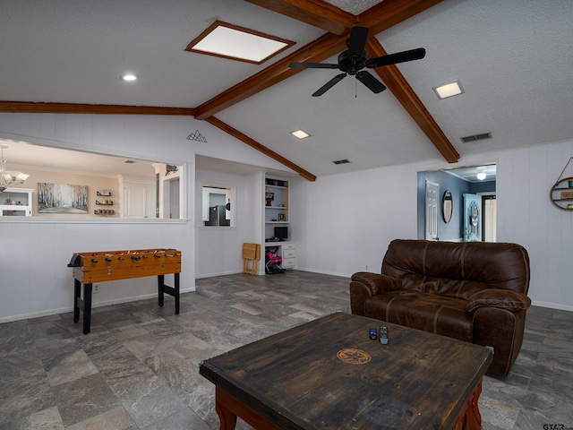 living room with lofted ceiling with beams, ceiling fan with notable chandelier, wooden walls, and built in shelves