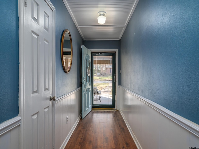 entryway with crown molding and dark wood-type flooring