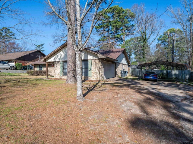 view of home's exterior featuring a carport, a garage, and a lawn