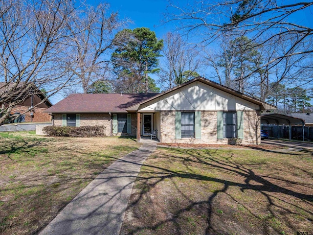 ranch-style home featuring a carport and a front yard