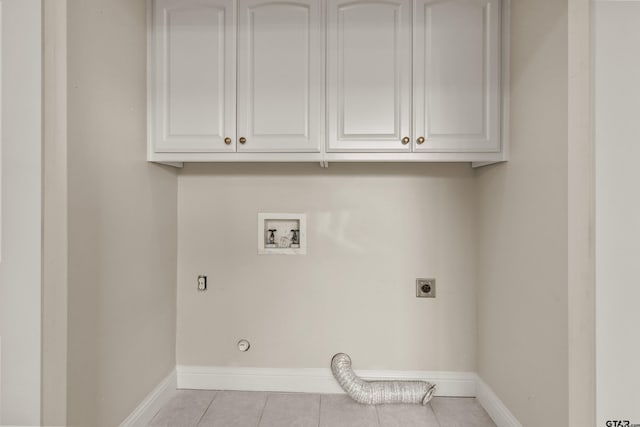 laundry room featuring cabinets, light tile patterned floors, hookup for an electric dryer, hookup for a washing machine, and hookup for a gas dryer