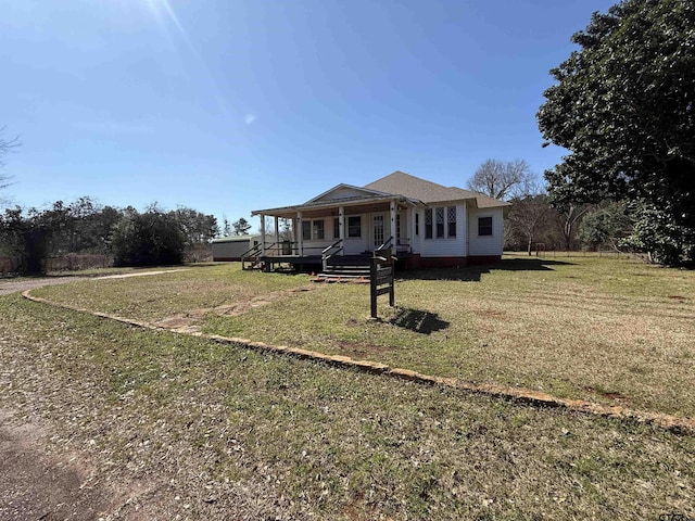 view of front of home featuring a front yard and covered porch