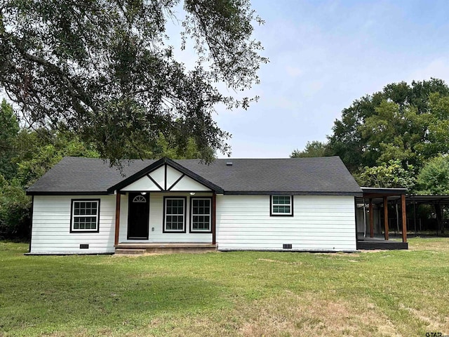 view of front of home with a carport, crawl space, roof with shingles, and a front lawn