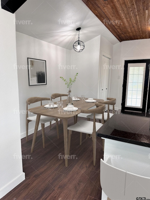 dining area featuring dark wood-type flooring, wooden ceiling, and baseboards