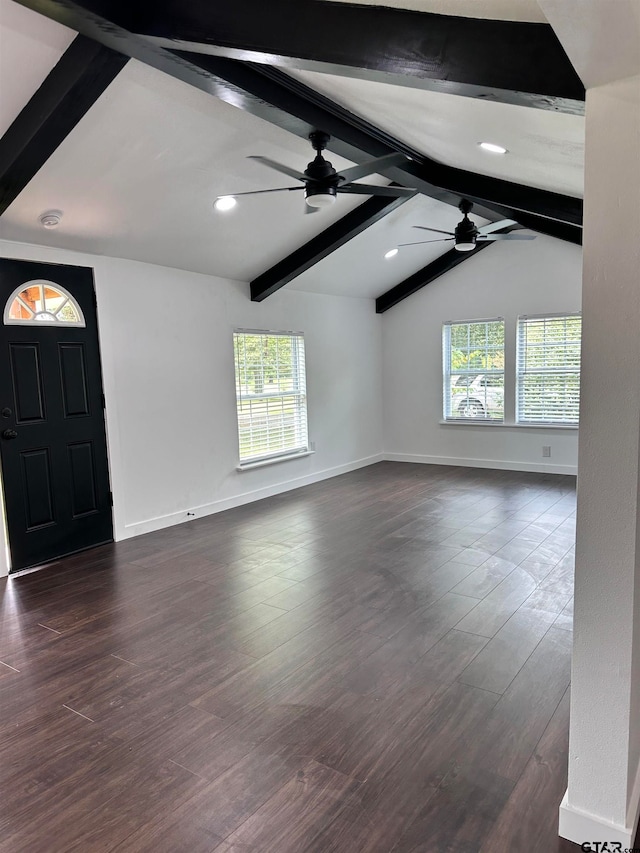 interior space with dark wood-style flooring, ceiling fan, lofted ceiling with beams, and baseboards