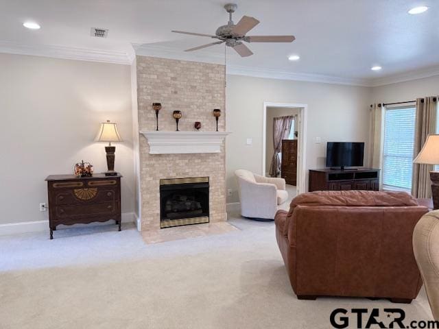 living room featuring a large fireplace, light colored carpet, and crown molding