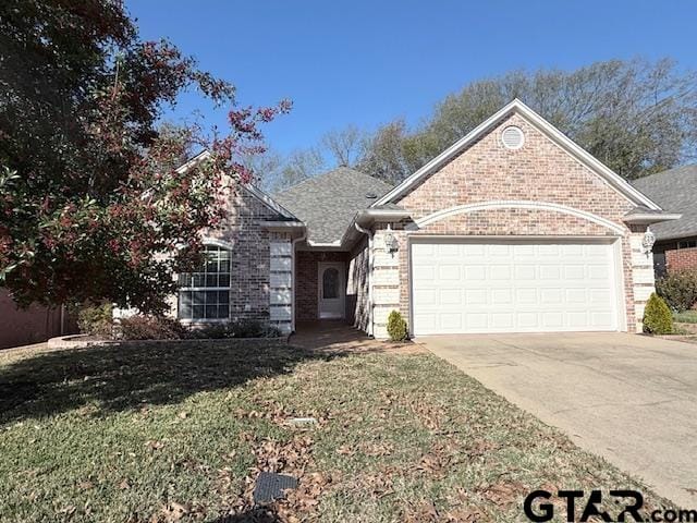 view of front of home with a garage and a front lawn