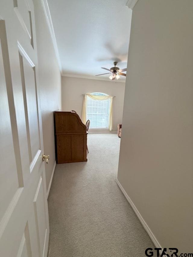 hallway with light colored carpet and ornamental molding