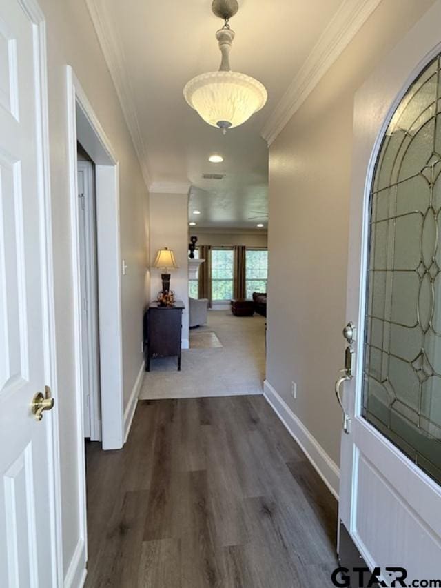 interior space featuring crown molding and dark hardwood / wood-style flooring