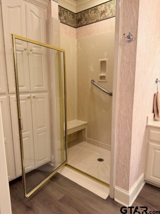 bathroom featuring hardwood / wood-style flooring and an enclosed shower