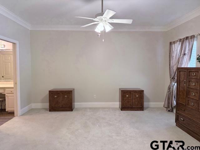 carpeted bedroom with ensuite bathroom, crown molding, and ceiling fan