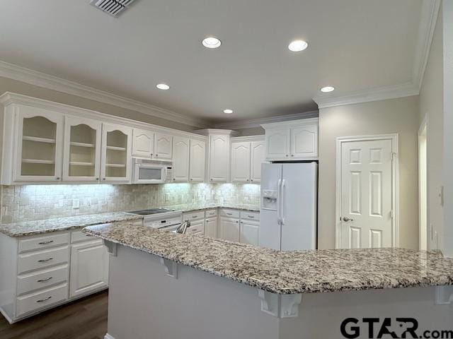 kitchen featuring white cabinets, white appliances, crown molding, and backsplash