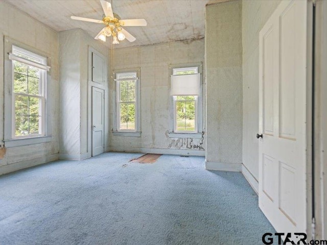 carpeted empty room with ceiling fan