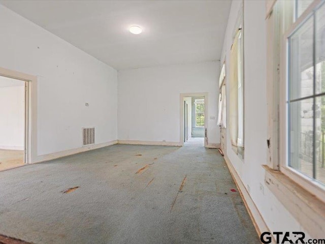 spare room featuring carpet and visible vents