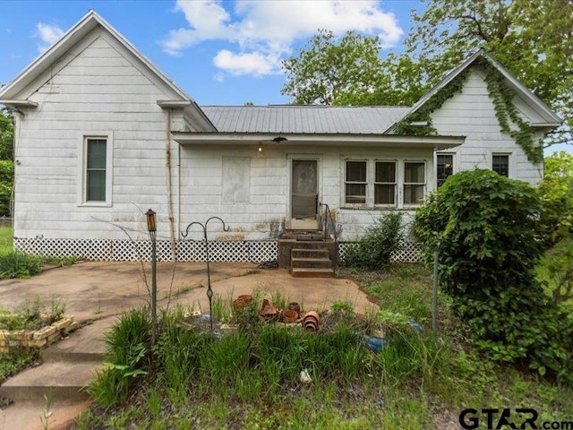 view of front of home featuring metal roof and entry steps