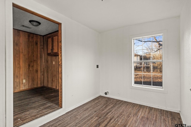 empty room featuring dark hardwood / wood-style flooring