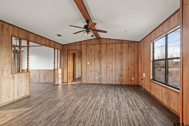 spare room featuring vaulted ceiling with beams, dark wood-type flooring, a textured ceiling, and ceiling fan