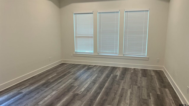 unfurnished room featuring dark hardwood / wood-style flooring