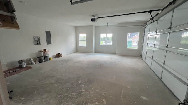 garage with electric panel and a garage door opener