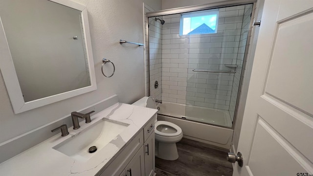 full bathroom with enclosed tub / shower combo, wood-type flooring, vanity, and toilet