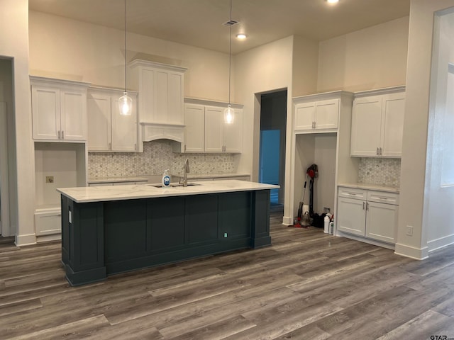 kitchen featuring hanging light fixtures, dark hardwood / wood-style floors, white cabinets, and decorative backsplash