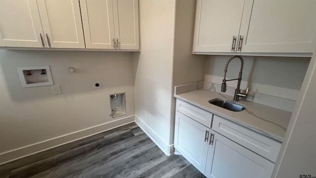 clothes washing area with hookup for an electric dryer, dark wood-type flooring, cabinets, sink, and washer hookup