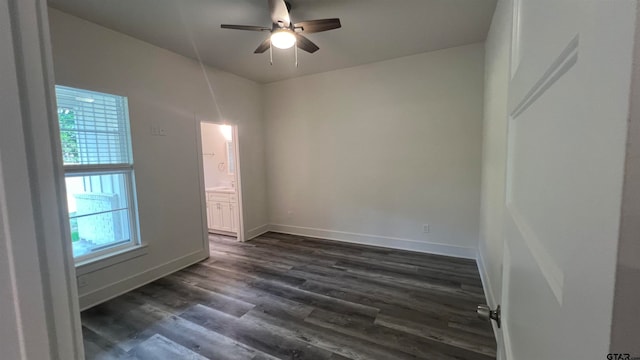 empty room with dark hardwood / wood-style flooring and ceiling fan