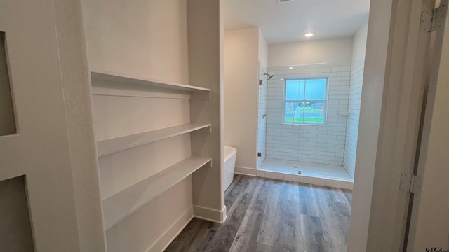 bathroom with plus walk in shower and hardwood / wood-style floors