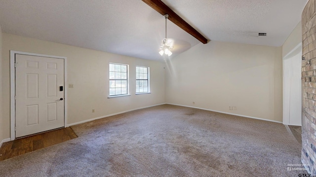 foyer entrance featuring ceiling fan, a textured ceiling, carpet flooring, and vaulted ceiling with beams