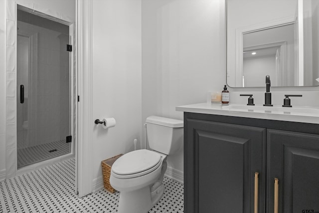 bathroom featuring a shower stall, baseboards, toilet, tile patterned floors, and vanity