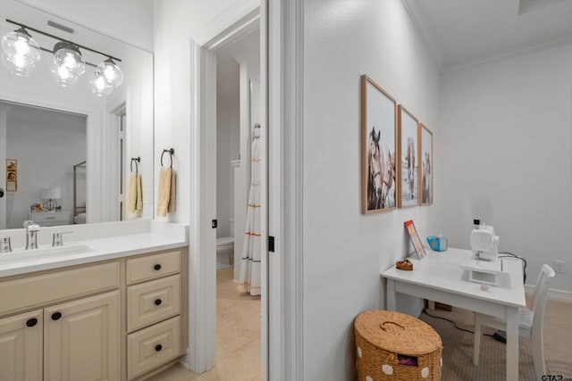 bathroom with toilet, ornamental molding, vanity, and tile patterned flooring