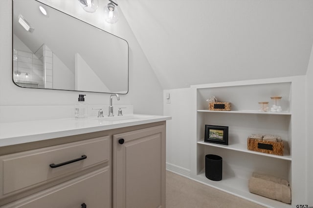 bathroom with vanity and vaulted ceiling