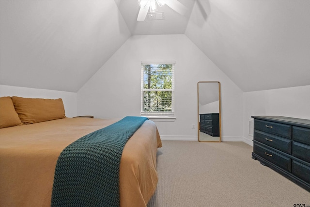 bedroom featuring light carpet, baseboards, a ceiling fan, and lofted ceiling