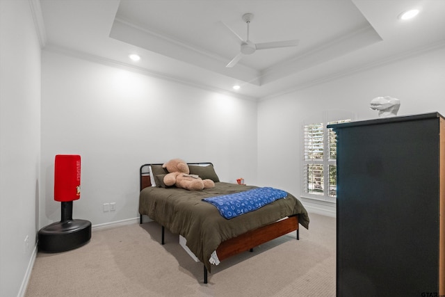 carpeted bedroom with recessed lighting, a tray ceiling, baseboards, and ornamental molding