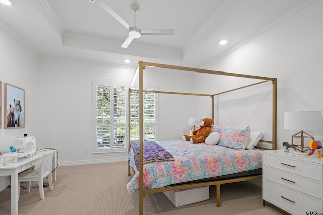 bedroom featuring ceiling fan, a raised ceiling, light colored carpet, and ornamental molding