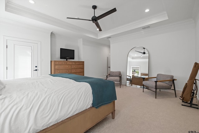 bedroom featuring light carpet, visible vents, a tray ceiling, and ornamental molding