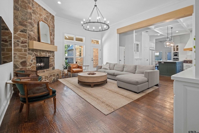 living room featuring coffered ceiling, an inviting chandelier, a fireplace, dark wood-style flooring, and beamed ceiling