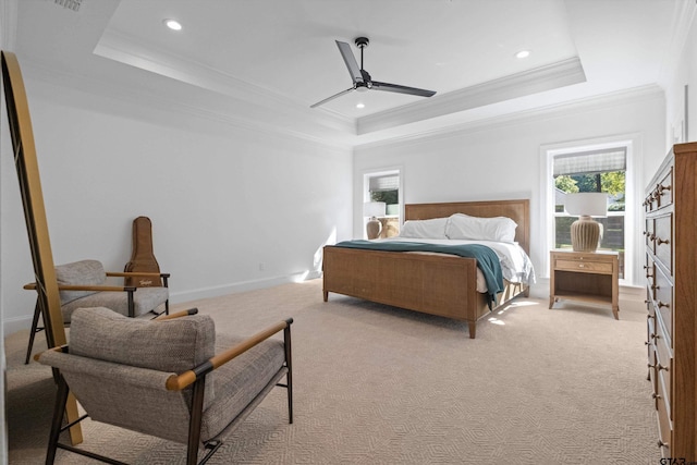 bedroom featuring light carpet, crown molding, and a raised ceiling