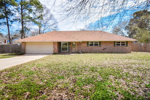 ranch-style home with a garage, driveway, fence, and a front lawn