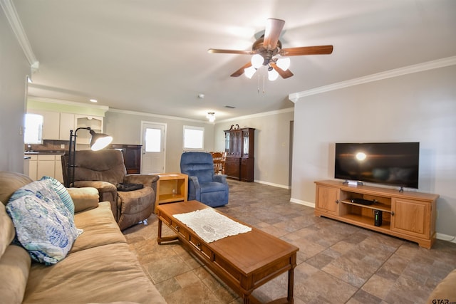 living room featuring crown molding, baseboards, and ceiling fan