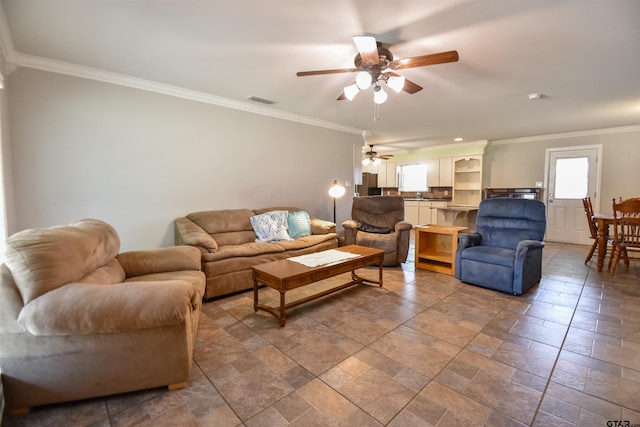 living room with ceiling fan, ornamental molding, and visible vents