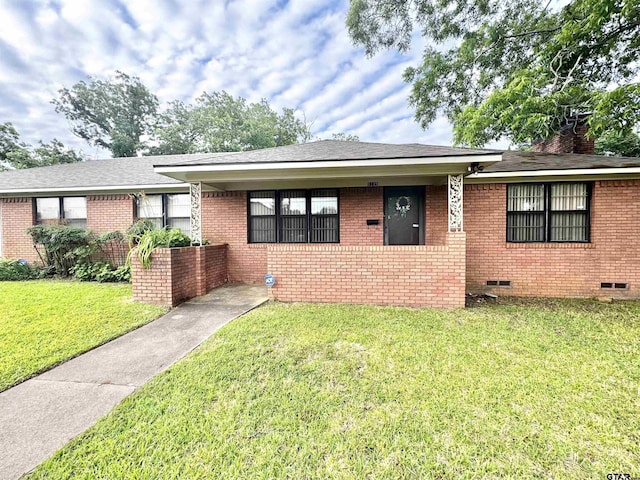 1115 Sunset Ave, Jacksonville, TX 75766 - bungalow featuring a front lawn, brick siding, crawl space, a chimney, and roof with shingles