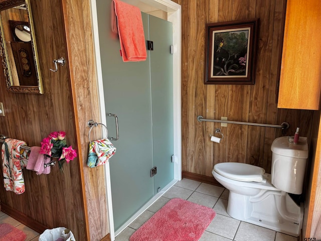 bathroom featuring toilet, wooden walls, and tile patterned floors