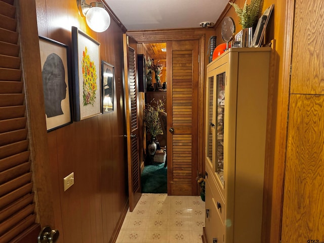 hallway with wooden walls and crown molding