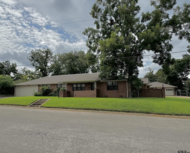 single story home with a garage and a front lawn